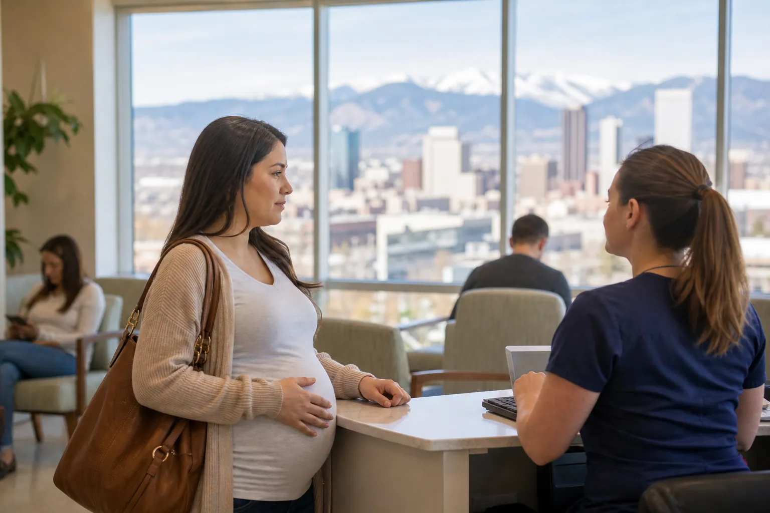Pregnant Woman at a Clinic Reception Desk A pregnant woman speaks with a staff member at a clinic reception desk, with seated patients and mountains visible behind them.