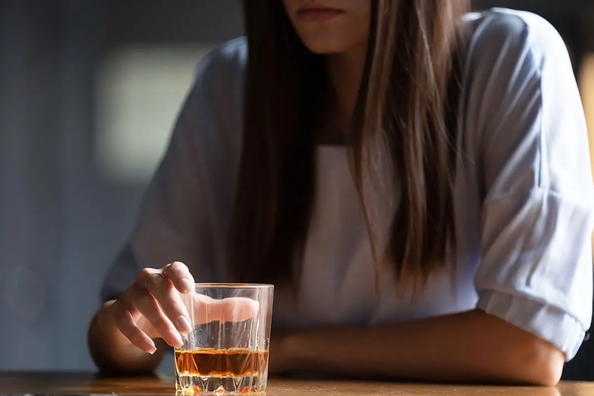 a woman ponders the signs of alcoholism