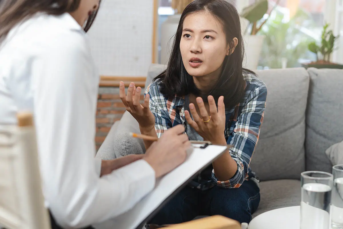 young woman discussing relapse prevention plan with therapist
