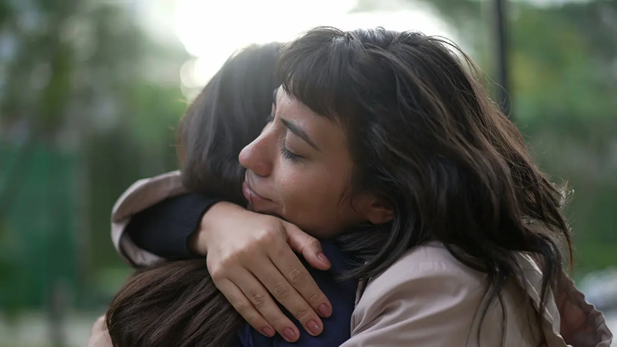 two women hugging after asking does your loved one have a prescription drug addiction