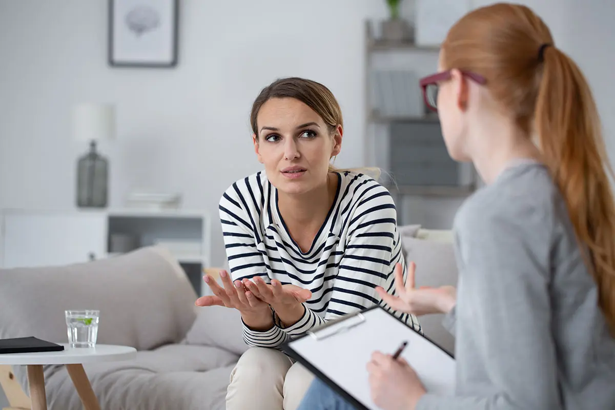 Woman discussing the pros and cons of marijuana legalization with a female therapist