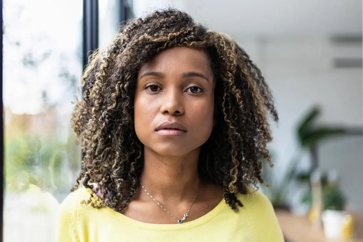 young woman looking at camera with worried expression wondering what is trauma-informed care?