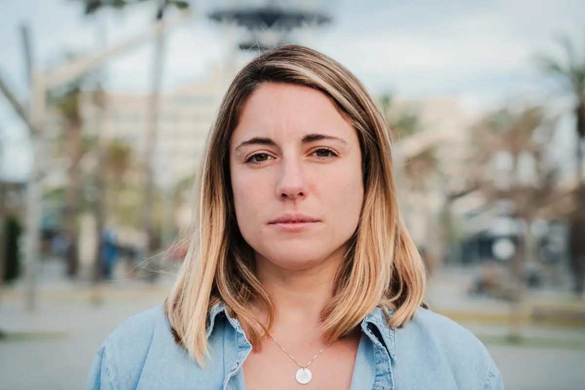 young woman walking along street during the daytime with a serious look on her face as she ponders females taking fluoxetie and what to know about side effects.