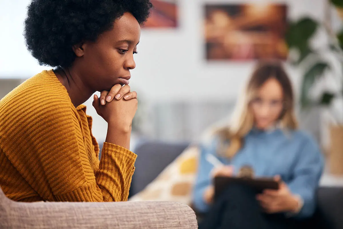 female therapist talking to female client about how to get mental health help for a loved one.
