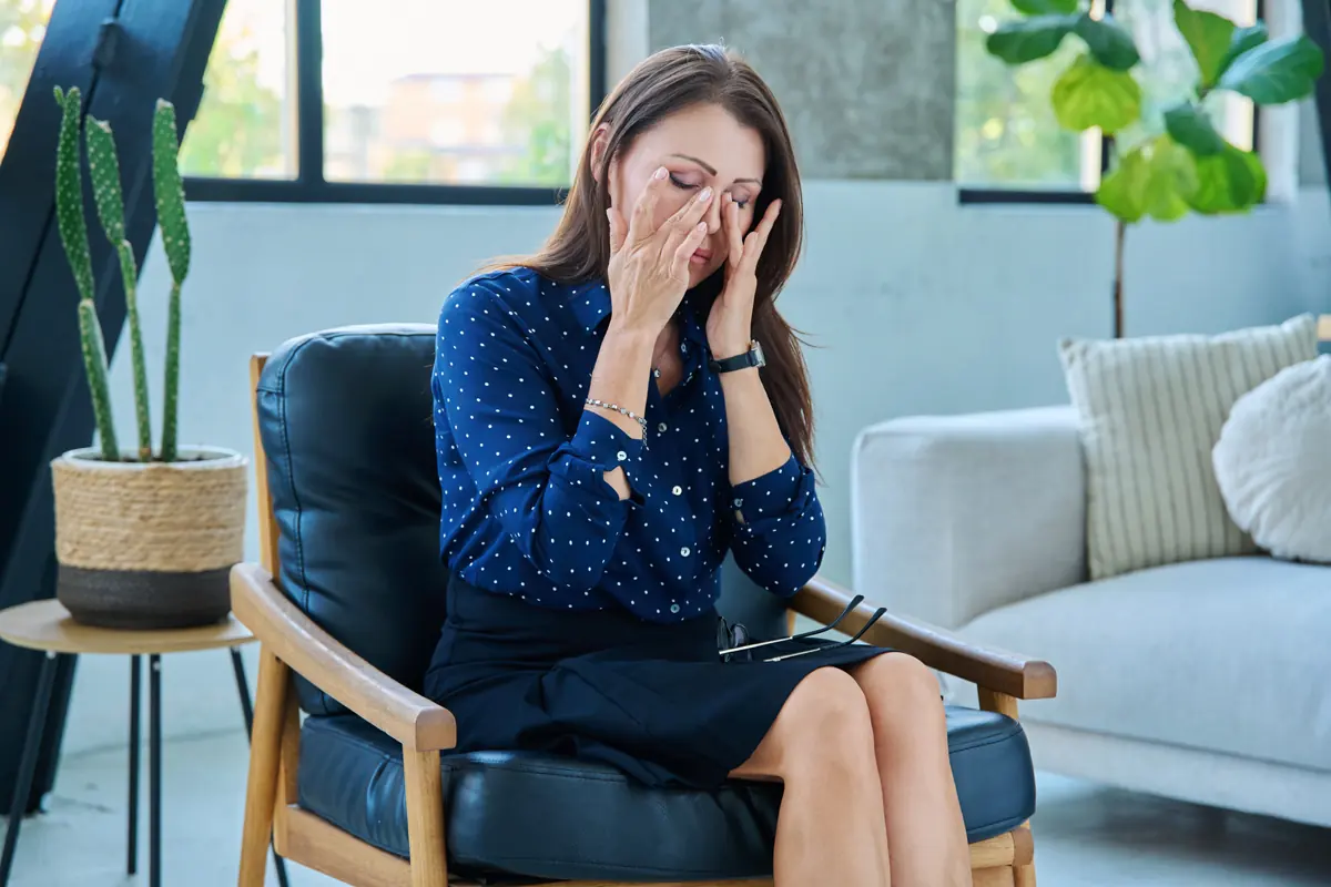 Woman exhausted and sitting in chair
