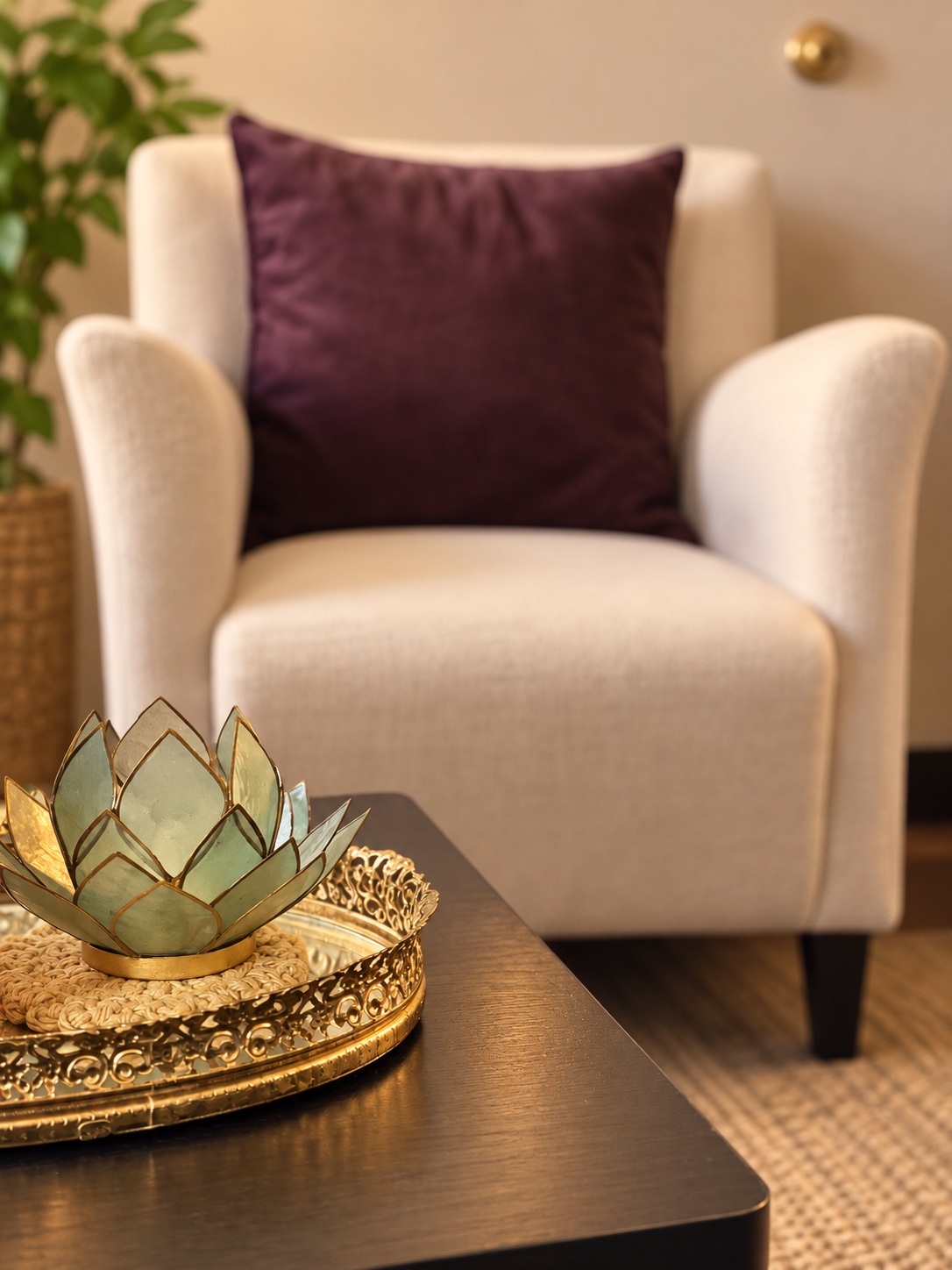 Empty cream chair with a purple cushion and lotus ornament