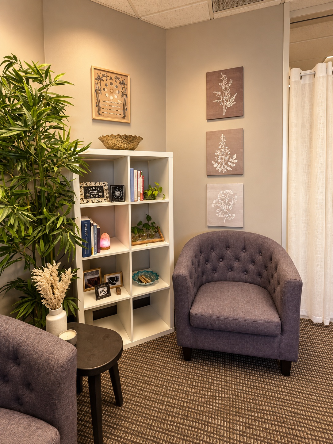 Two upholstered chairs and a bookshelf in a Women’s Recovery office