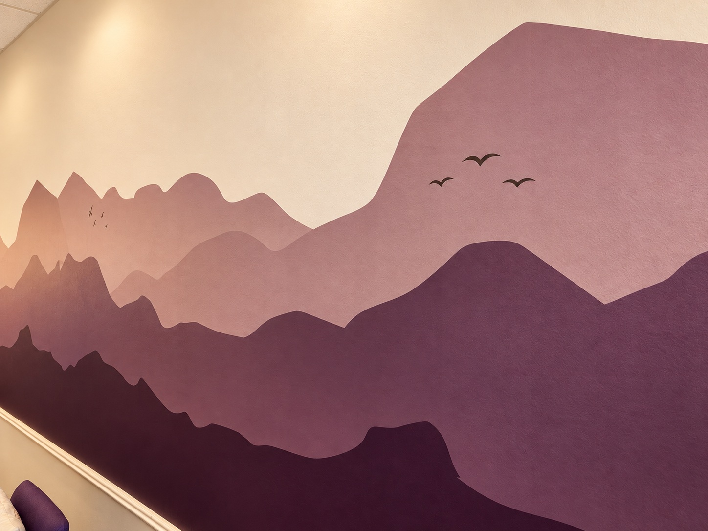 Mauve mountain mural with birds