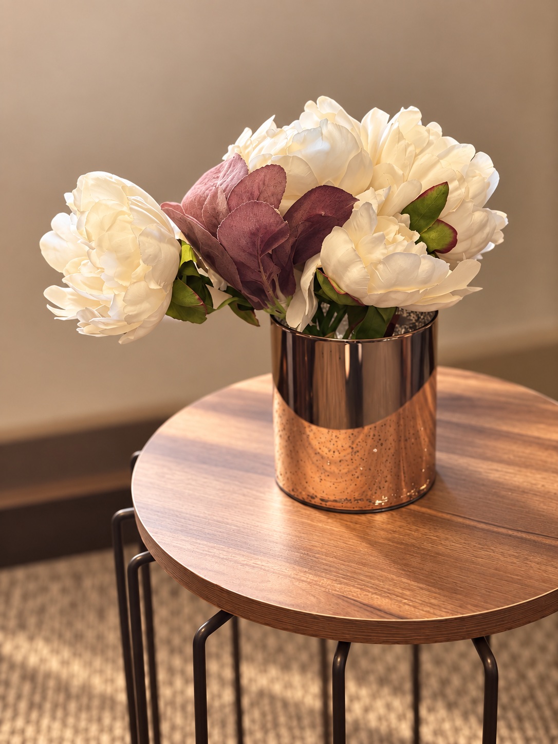 Bouquet in a metal vase on a round table