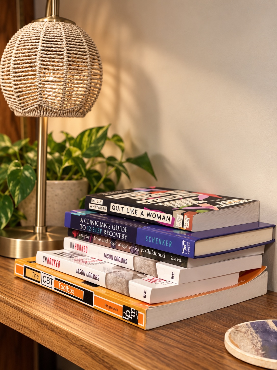 Therapy books beside a woven lamp