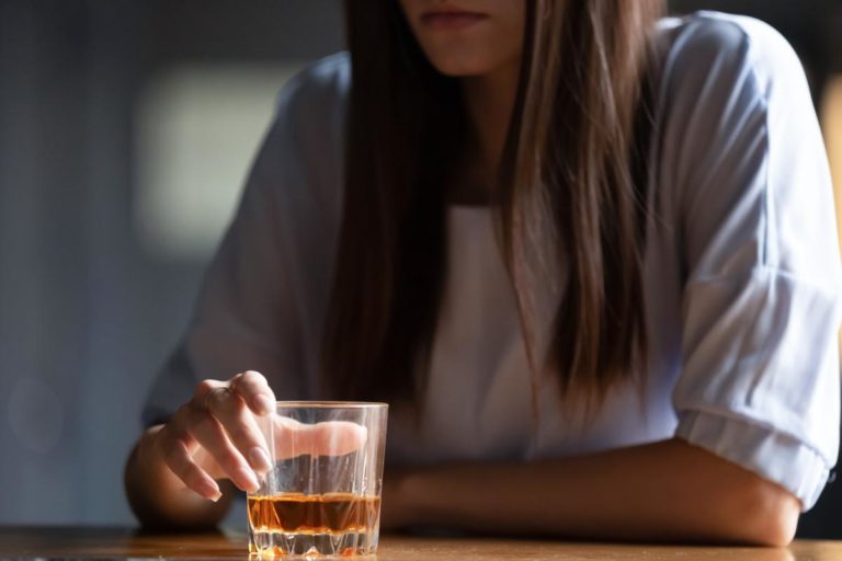 Woman suffering from both alcohol and depression