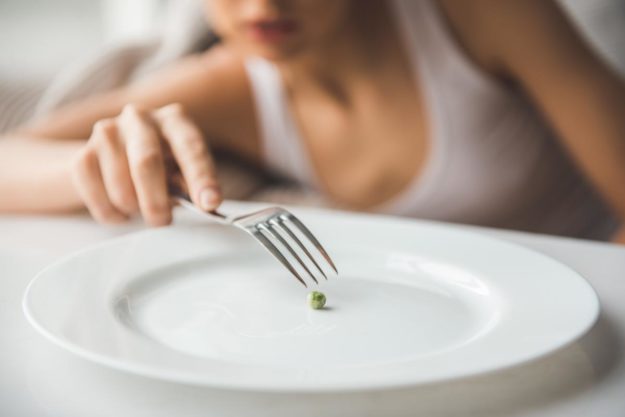 How to Cope With an Eating Disorder During the Holidays a woman struggles with an eating disorder during the holidays