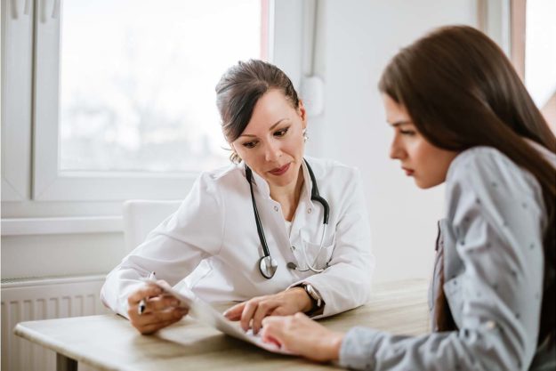 Charming female doctor giving advice to a female patient. a doctor explains medication assisted treatment