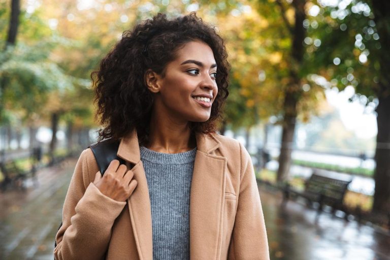 mentally healthy woman happy and walking on city sidewalk