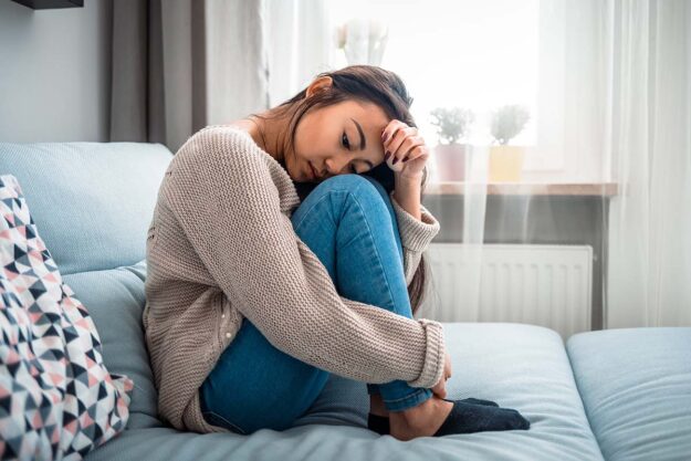 How Alcohol Affects Physical Appearance of Women tired and hungover young woman learning how alcohol affects physical appearance of women