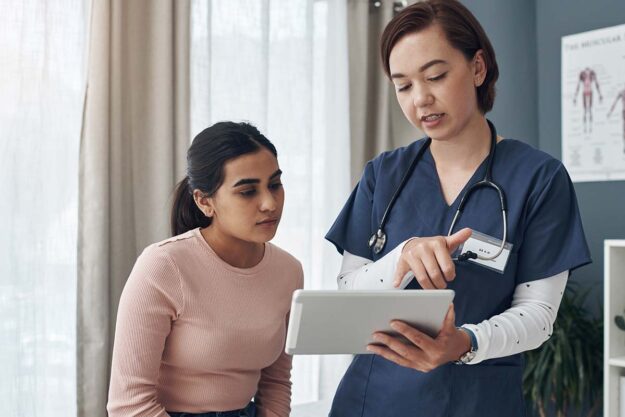 What Are Rivotril Overdose Symptoms Nurse discussing Rivotril overdose symptoms with her client