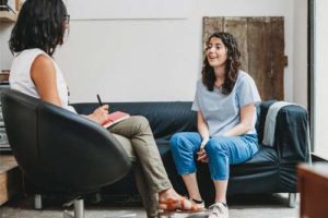 therapist talking to female client about substance abuse treatment programs