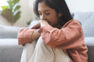 concerned young woman wondering if she should take a drug addiction quiz to determine if she is at risk