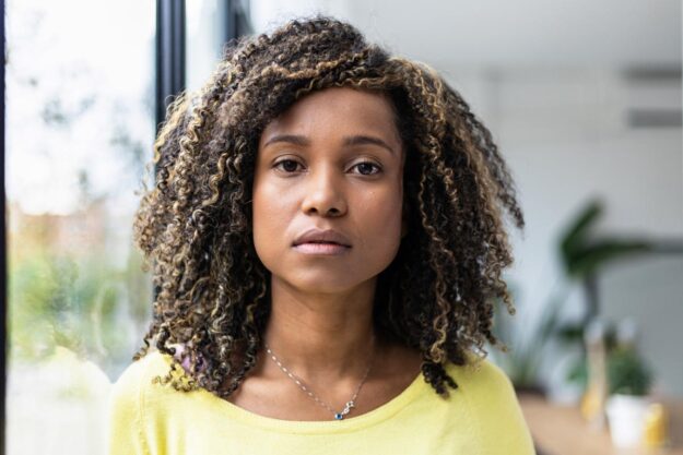 WHAT IS TRAUMA-INFORMED CARE_ young woman looking at camera with worried expression wondering what is trauma-informed care?