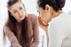  A therapist discusses Percocet addiction treatment with a distressed young woman