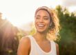 smiling young woman walking on a sunny day after learning how to set boundaries for your mental health