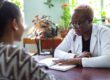 female behavioral health specialist meeting with young woman in an office setting to explain what to expect after TMS treatment.