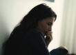 distraught woman seated alone in her room looking uncertain about the effects of alcohol on women's health