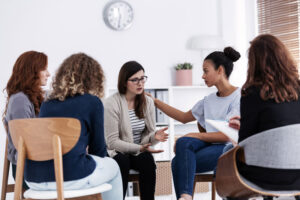 group of women seated in a circle and sharing stories as part of women's alcohol rehab in Denver,CO
