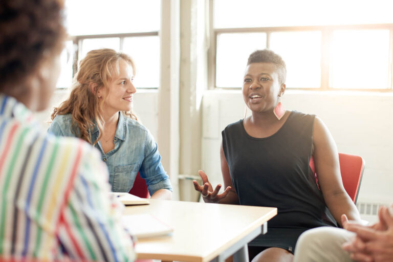 women in a group setting discuss the benefits of gender-specific addiction treatment for women in colorado