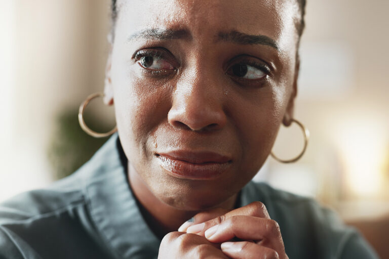 woman looks at counselor while learning about how PTSD and addiction are linked in women