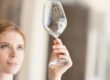 Woman looking at empty wine glass