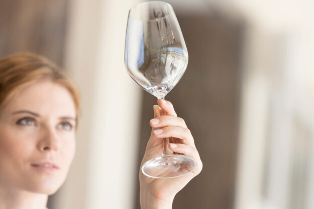 Woman looking at empty wine glass