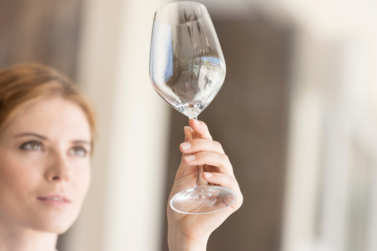 Woman looking at empty wine glass