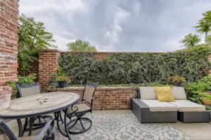 Back paved patio at Women's Recovery with couch and table